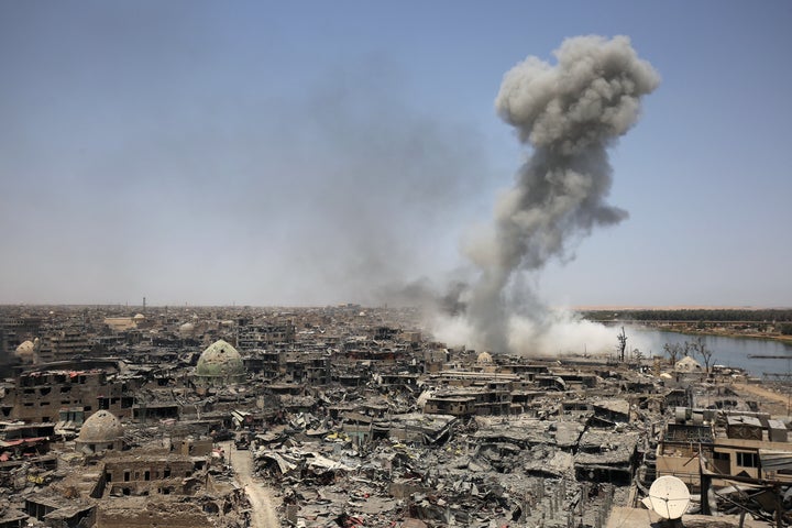 Smoke billows following an airstrike in Mosul by the U.S.-led international coalition on Sunday. Iraqi Prime Minister Haider al-Abadi congratulated the armed forces as the end of the battle for the city nears.