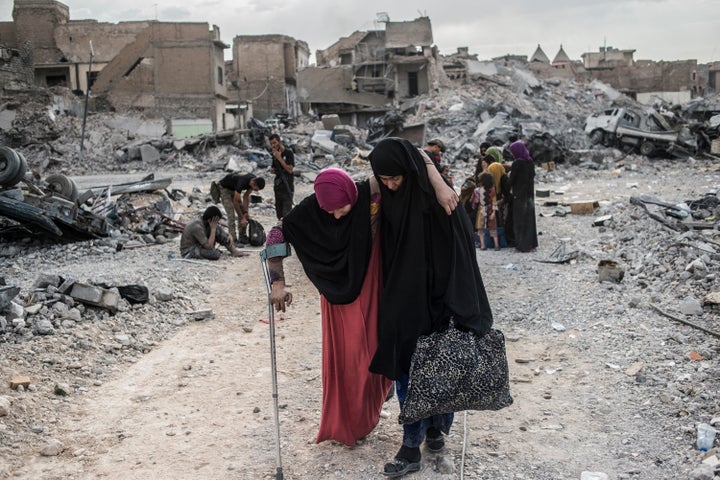 An injured woman arrives at an Iraqi forces checkpoint amid heavy fighting in the Old City of Mosul on Saturday.