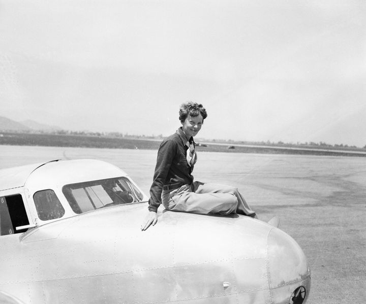Earhart seated atop the cockpit of the twin-motored, all-metal, Lockheed-Elecktra monoplane