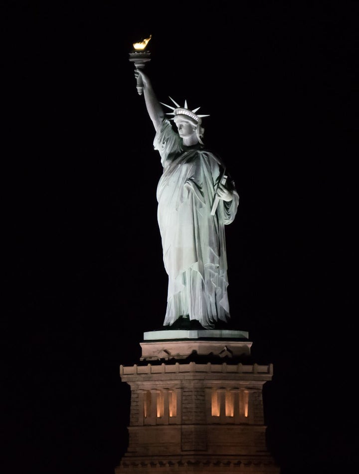 The Statue of Liberty at night, seen from the Staten Island Ferry