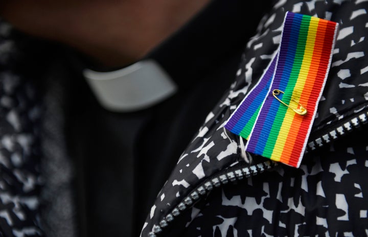 A priest wears a rainbow ribbon during a vigil against Anglican Homophobia, outside the General Synod of the Church of England in London, Britain, February 15, 2017. 