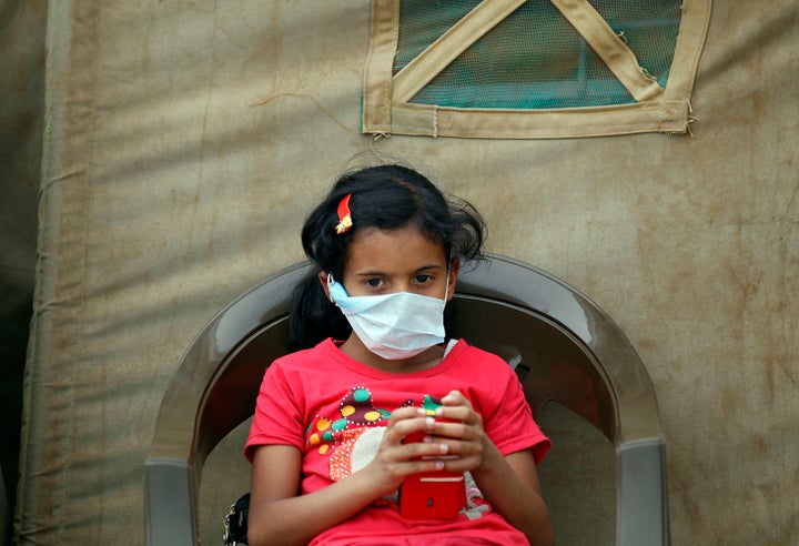 A Yemeni child sits outside a makeshift hospital in Sanaa on June 5, 2017.