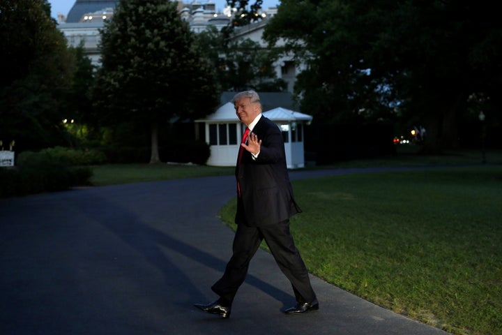 President Donald Trump waves as he walks on the South Lawn of the White House on July 8 after returning to the U.S. from the&
