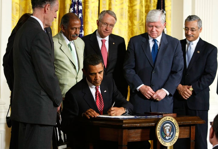 President Barack Obama signs the Fraud Enforcement and Recovery Act into law as congressional leaders look on during a ceremony in the East Room of the White House May 20, 2009.