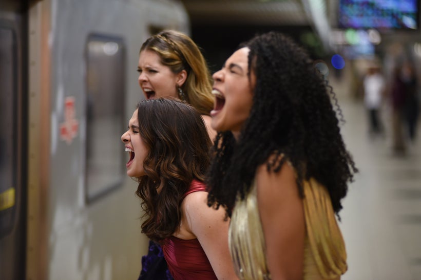 Spirited young millennials perform the traditional ritual of shouting at a passing A Train.