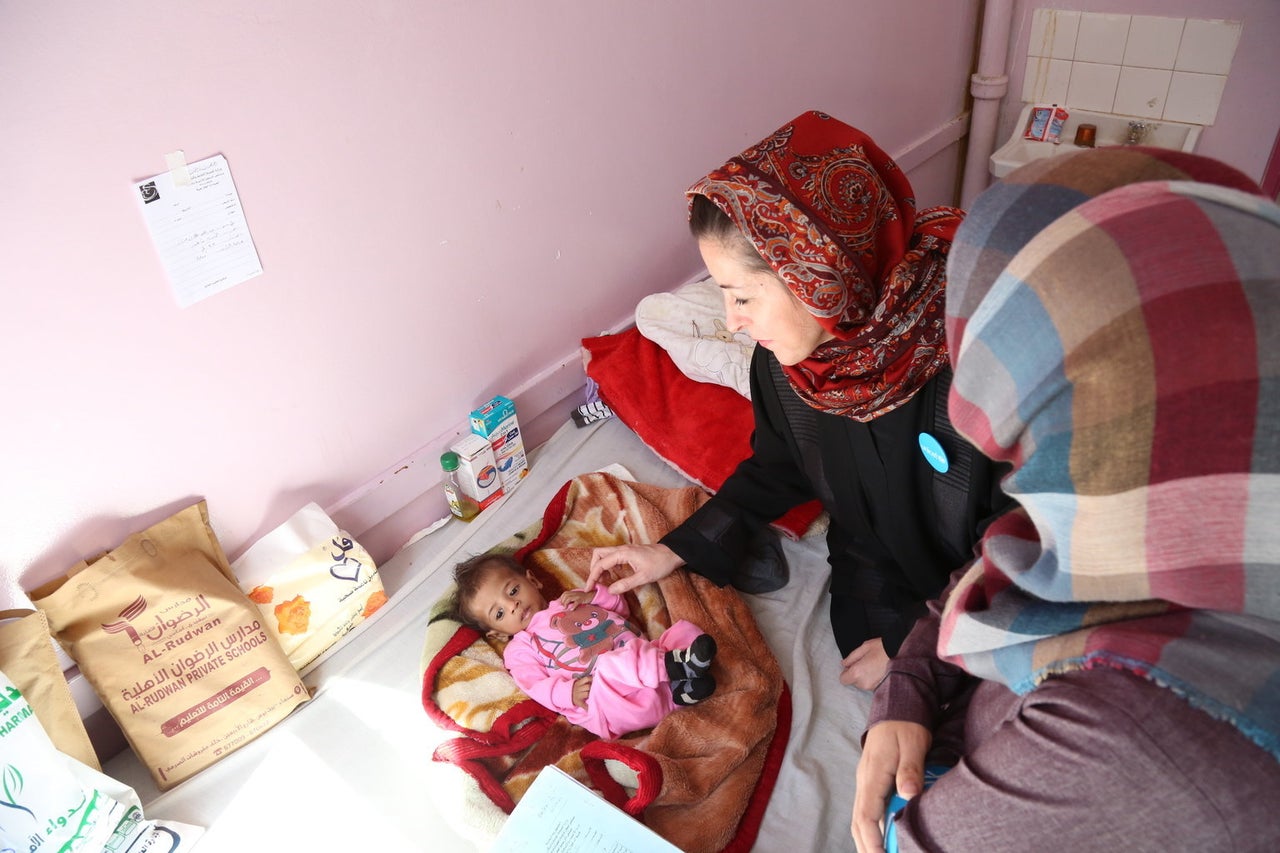 Meritxell Relano, UNICEF representative in Yemen, checks on a boy suffering from malnutrition at the al-Sabeen hospital in Sanaa on Jan. 19, 2017.