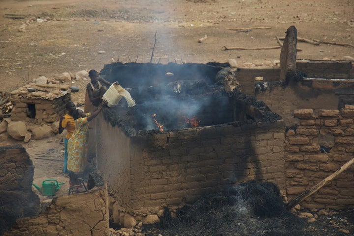 <p>Women in the Nuba Mountains work to put out a fire, after a home was bombed by Sudan war planes.</p>