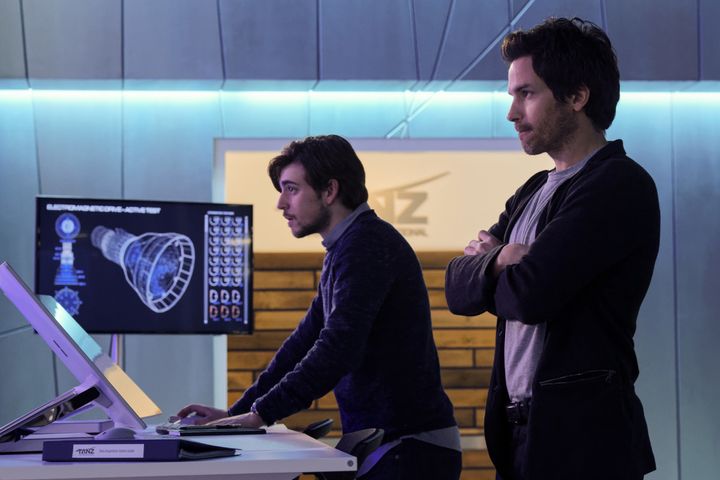 Charlie Rowe as Liam and Santiago Cabrera as Darius, two geniuses who are on a deadline to save humanity.
