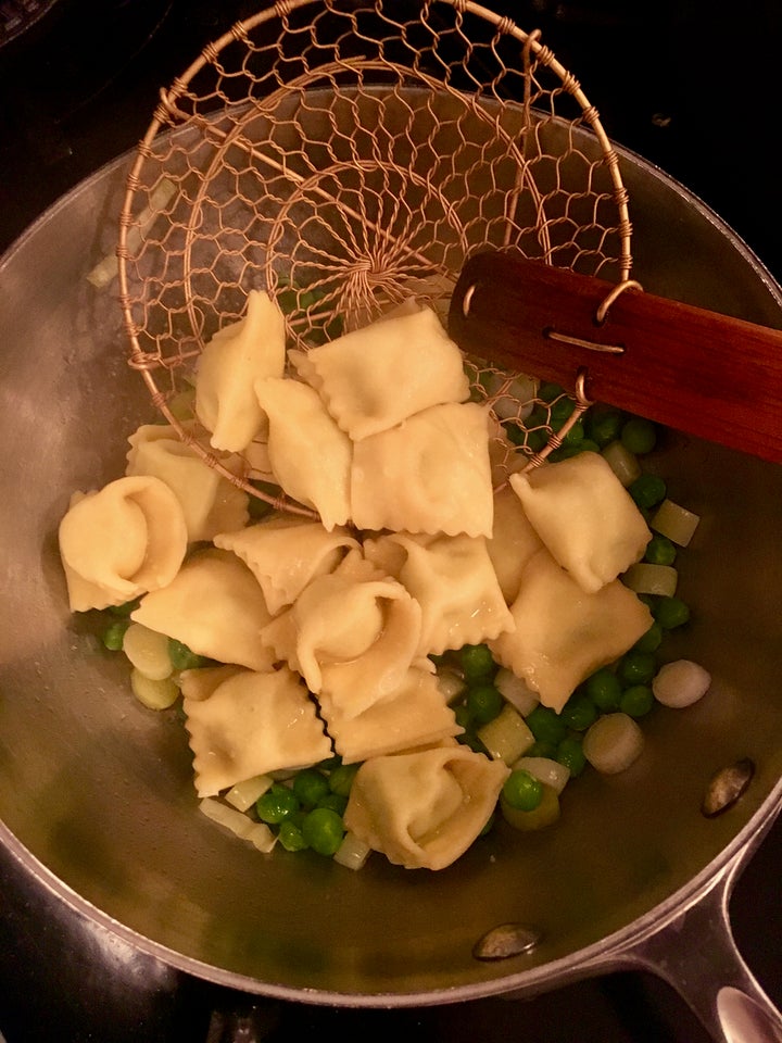 Ravioli going into the pan