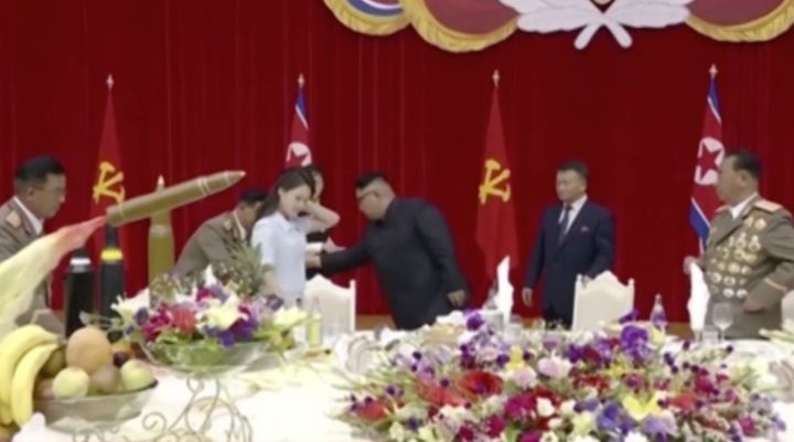 Kim Jong Un (centre) and his wife Ri Sol Ju (left) attended a banquet to celebrate the successful launch of the country's first intercontinental ballistic missile