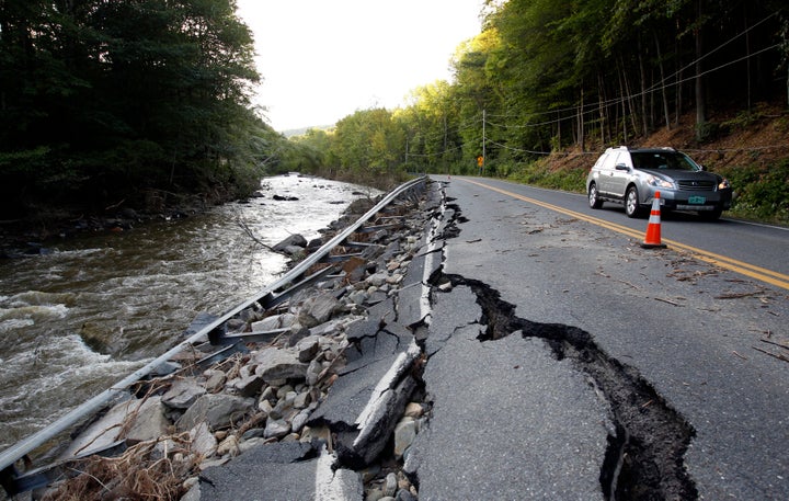 A car passes a section of Route 112 that was washed out during Hurricane Irene in Halifax, Vermont August 29, 2011.