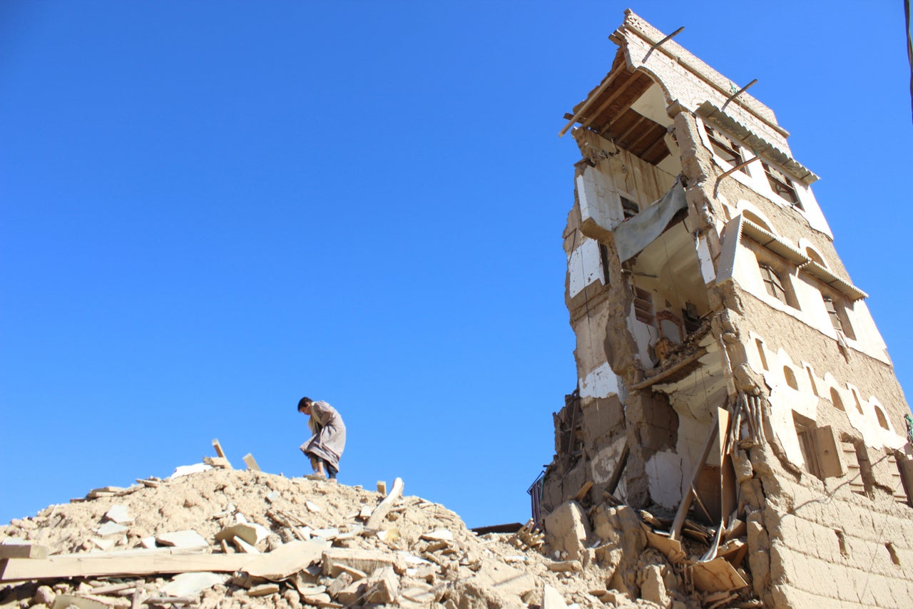 A boy walks on the rubble of a house destroyed by a recent Saudi-led air strike in the northwestern city of Saada, Yemen on January 4, 2017