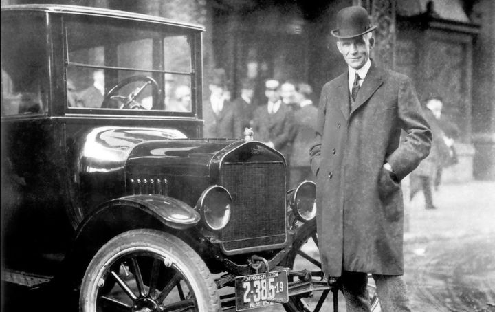 Henry Ford next to a Model T