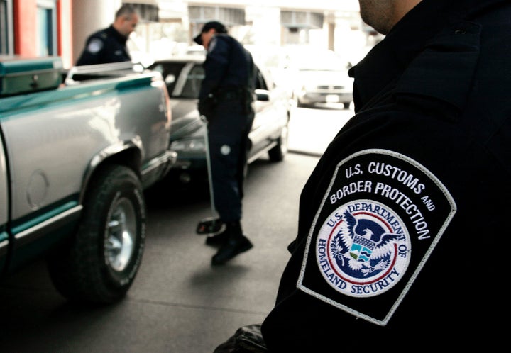 U.S. Customs and Border Protection agents inspect a vehicle coming into the U.S.