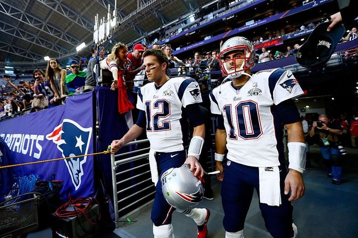 New England Patriots quarterback Tom Brady (left) walks out onto the field with backup quarterback Jimmy Garoppolo (right) for Superbowl XLIX.