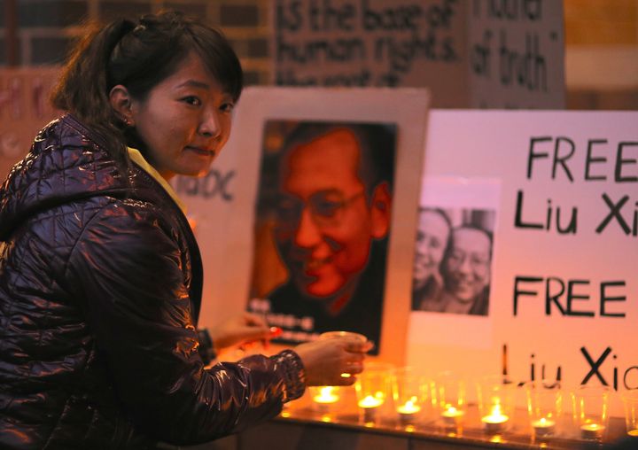 A member of the Tibetan community in Australia attends a candlelight vigil for Liu Xiaobo outside the Chinese Consulate in Sydney on July 12, 2017.