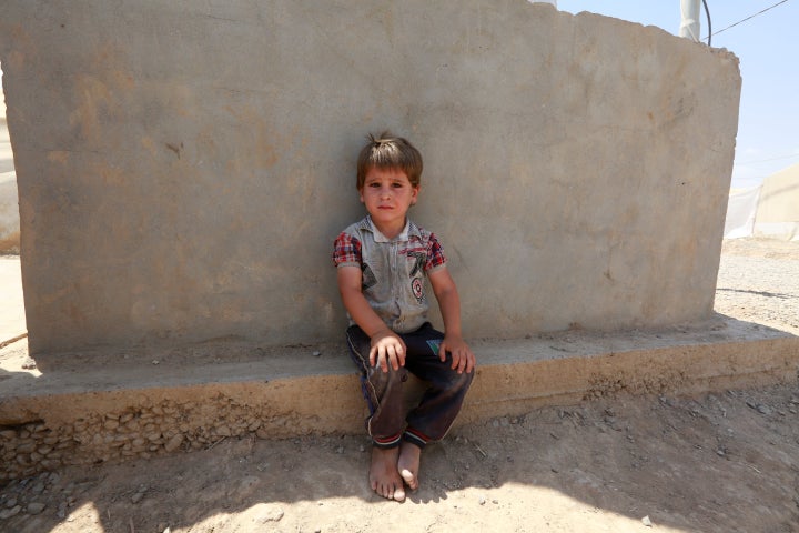 A displaced Iraqi child who fled home is pictured at a camp in Iraq on Wednesday.