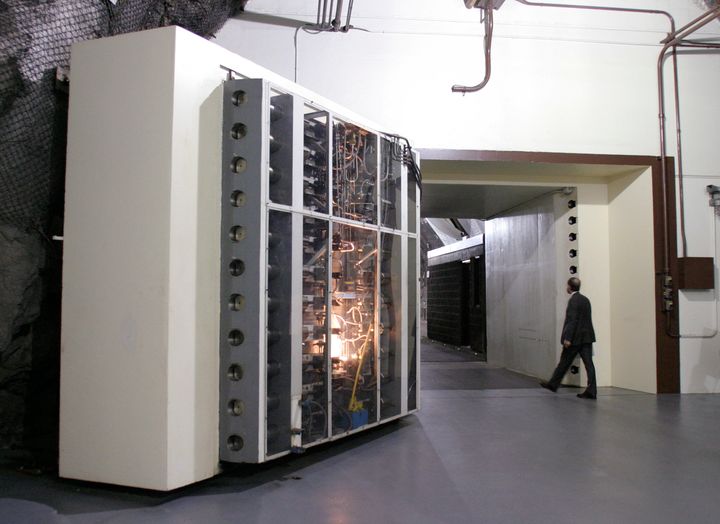 A visitor to the Cheyenne Mountain Operations center walks into the facility past a 3 foot thick, 25 ton blast door in Colorado Springs, Colorado, August 25, 2004.
