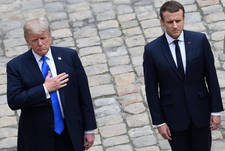 U.S. President Donald Trump, with his hand on his heart, and French President Emmanuel Macron listen to the national anthems during a welcome ceremony at Les Invalides in Paris on Thursday.
