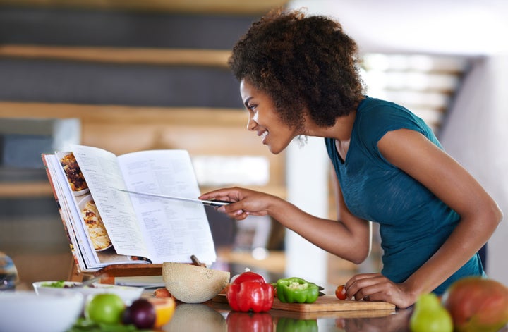 Someone focused, mindfully following a recipe.