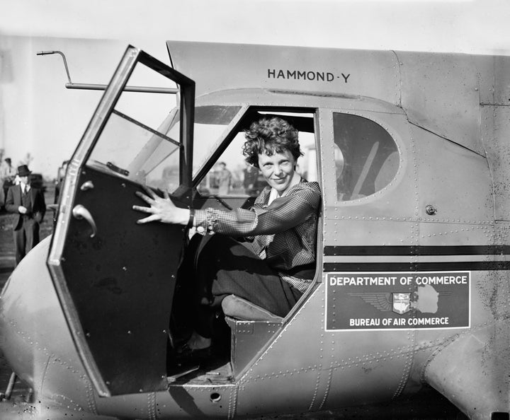 Earhart sitting in an airplane, 1936.