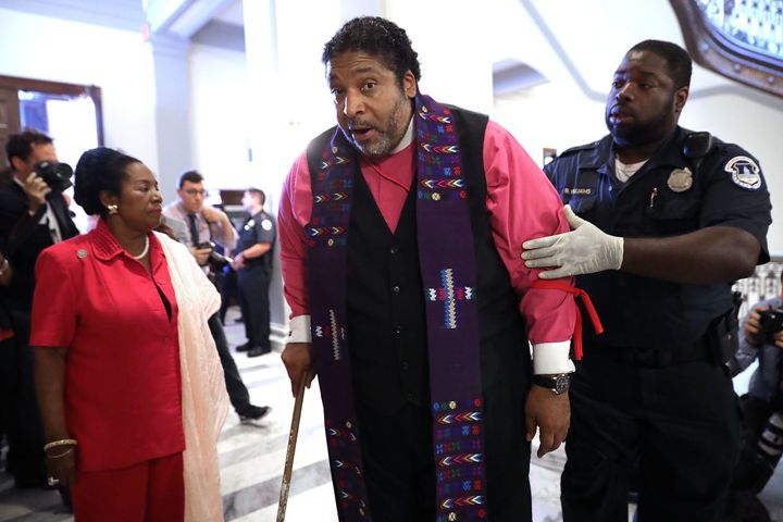 NAACP North Carolina President Rev. Dr. William Barber (C) is arrested for protesting against new GOP health care legislation in Senate Majority Leader Mitch McConnell's offices on Capitol Hill July 13, 2017 in Washington, DC. The latest version of the proposed bill aims to repeal and replace the Affordable Care Act, also knows as Obamacare. 