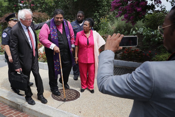 Sen. Bernie Sanders (I-VT) (L) and Rep. Sheila Jackson Lee (D-TX) walk with NAACP North Carolina President Rev. Dr. William Barber as he was being arrested for protesting against new GOP health care legislation in Senate Majority Leader Mitch McConnell's offices on Capitol Hill July 13, 2017 in Washington, DC. The latest version of the proposed bill aims to repeal and replace the Affordable Care Act, also knows as Obamacare. 