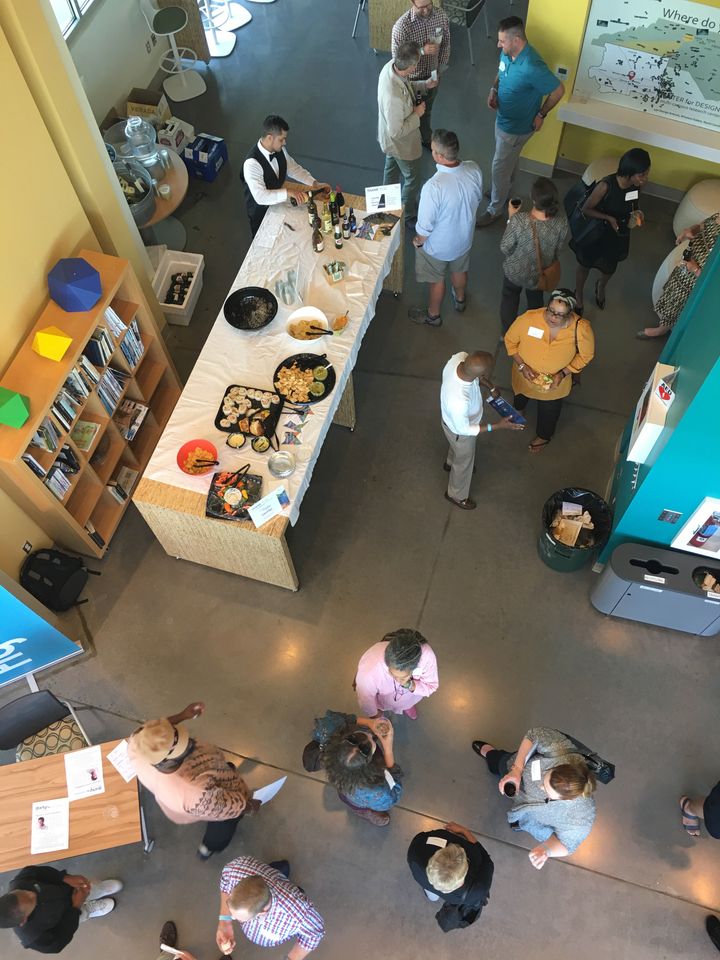 An aerial view of tasty treats, wine, and conversation at a Thursday Gathering in the Atrium of BioTech Place at Wake Forest. 
