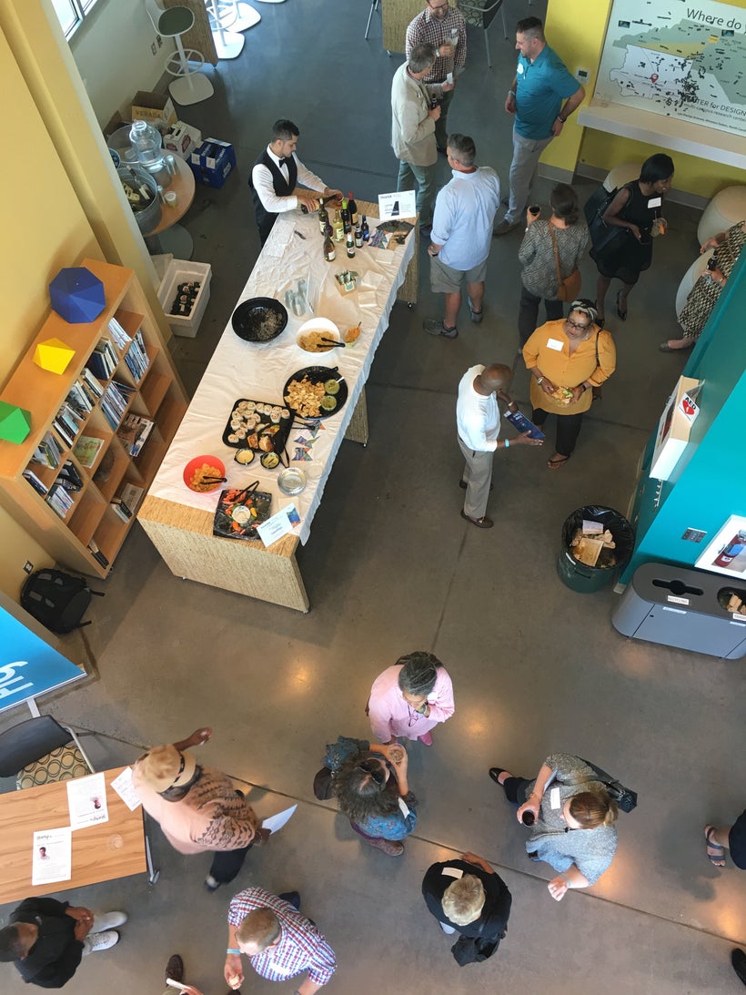 An aerial view of tasty treats, wine, and conversation at a Thursday Gathering in the Atrium of BioTech Place at Wake Forest.