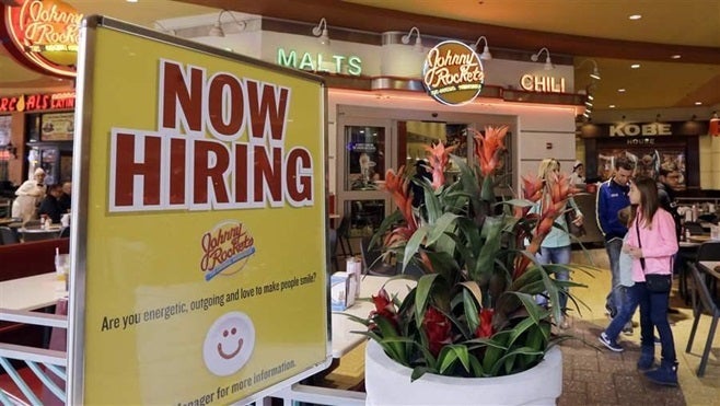 A restaurant in Miami advertises for more employees. In many states, the growing demand for service workers is prompting pay increases.