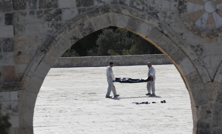Israeli policemen carry the body of an assailant after he was shot dead by Israeli police at the compound known to Muslims as Noble Sanctuary and to Jews as Temple Mount, in Jerusalem's Old City July 14, 2017.