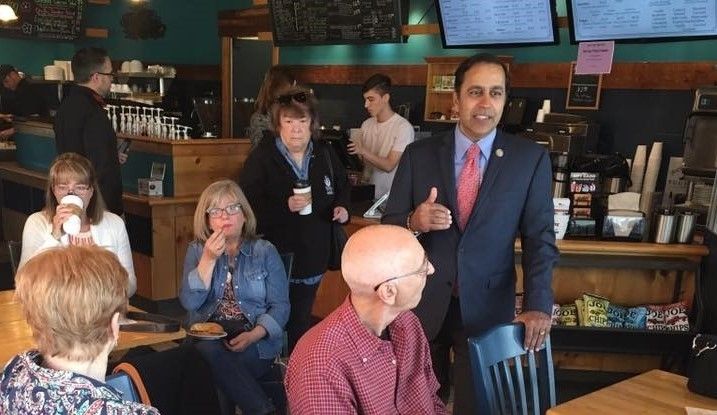 Congressman Krishnamoorthi meeting with constituents in a coffee shop in Schaumburg, IL.