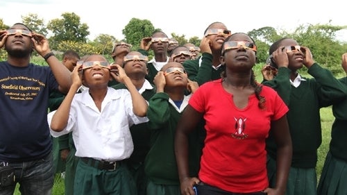 Students wearing eclipse glasses. You must wear these special glasses to look at the Sun during a solar eclipse safely. Exception: you can (and should) remove them during totality. 