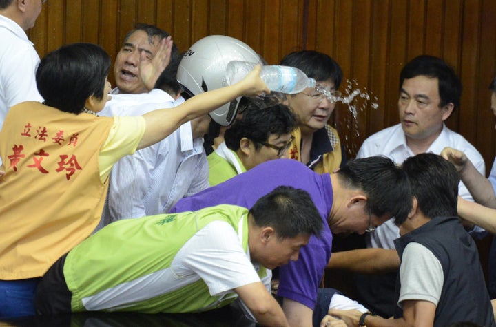 Taiwanese legislators fight in parliament on Aug. 2, 2013.