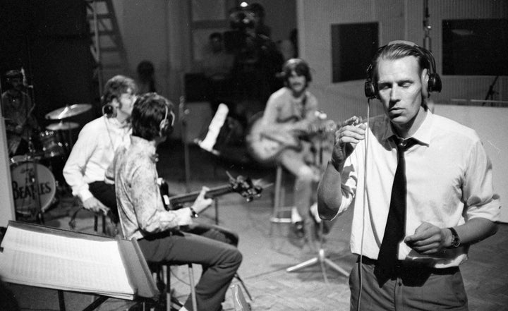 <p>George Martin (foreground) and the Beatles rehearsing “All You Need Is Love” in June 1967</p>