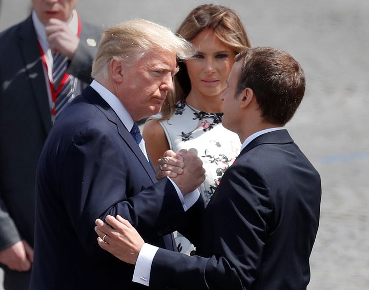 French President Emmanuel Macron locked in a Trump handshake.