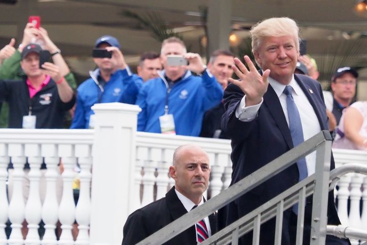 Donald Trump holding up three fingers.