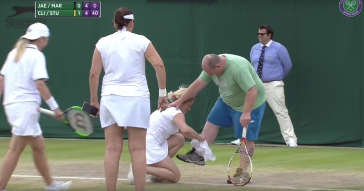 Kim Clijsters helps the man squeeze into a white skirt.