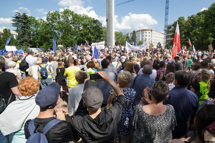 People participate in a protest in front of the Polish Parliament building in Warsaw, Poland on 16 July 2017.