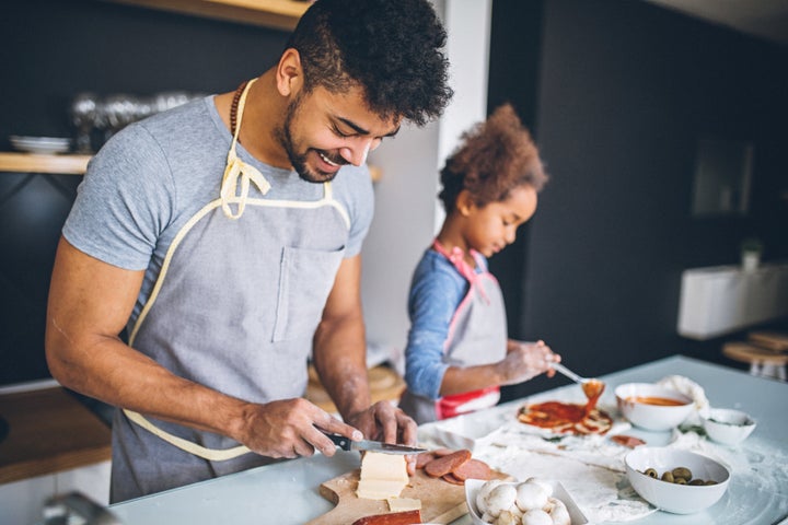 Dad cooking for his daughter.