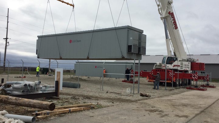 A container of batteries is installed in Minster, Ohio, the first local government to pair energy storage with solar power. Governments are eyeing energy storage as a way to reduce energy costs and carbon emissions.