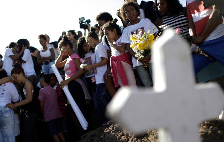Children mourn the death of a ten-year-old girl killed in crossfire between police and drug dealers in Rio, July 6 2017.