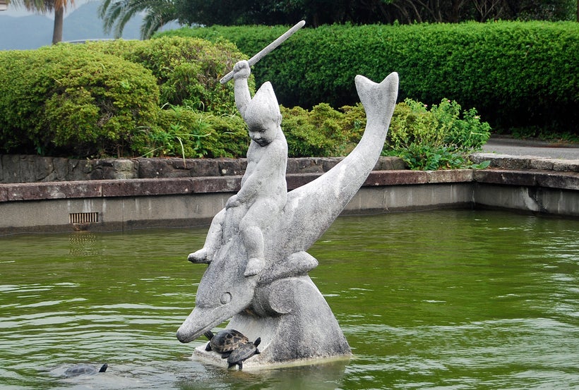 Statue of boy on dolphin, from the town of Taiji, Japan