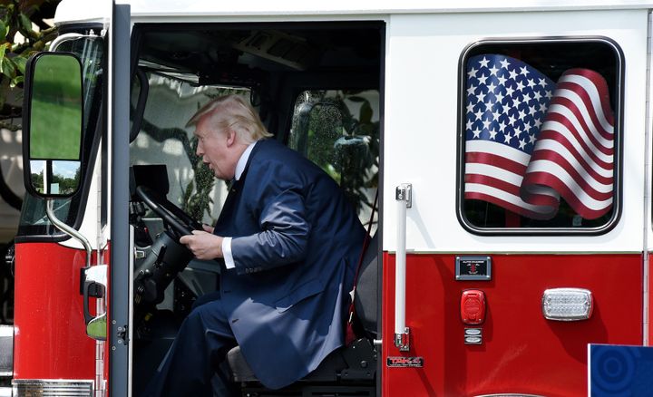President Donald Trump examines a firetruck from Wisconsin-based manufacturer Pierce on the South Lawn during a "Made in America" product showcase at the White House on Monday.