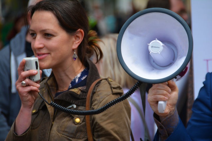 <p>SIGNAL BOOST: A male ally holds a megaphone.</p>