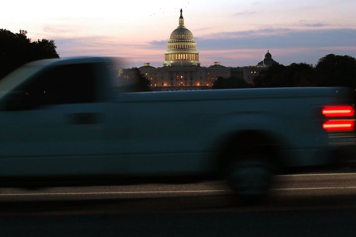 The sun begins to rise behind the U.S. Capitol on Tuesday.