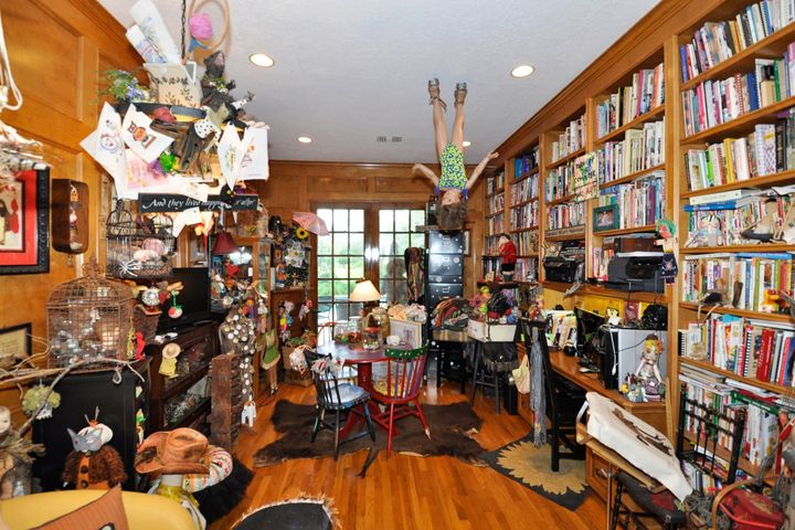 Reading or crafts room, with mannequin hanging from the ceiling.