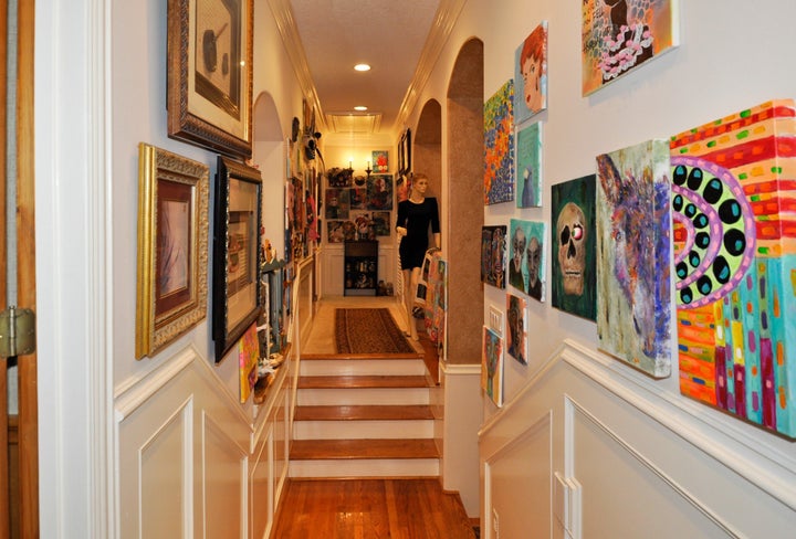 A hallway doubles as an art gallery. Note the docent.