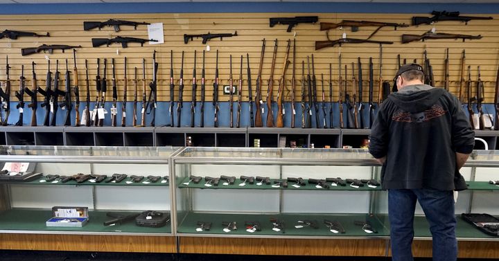 A customer looks over weapons for sale at the Pony Express Firearms shop in Parker, Colorado December 7, 2015.