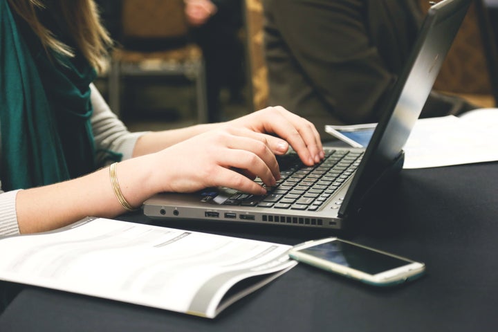 Woman type on a laptop.